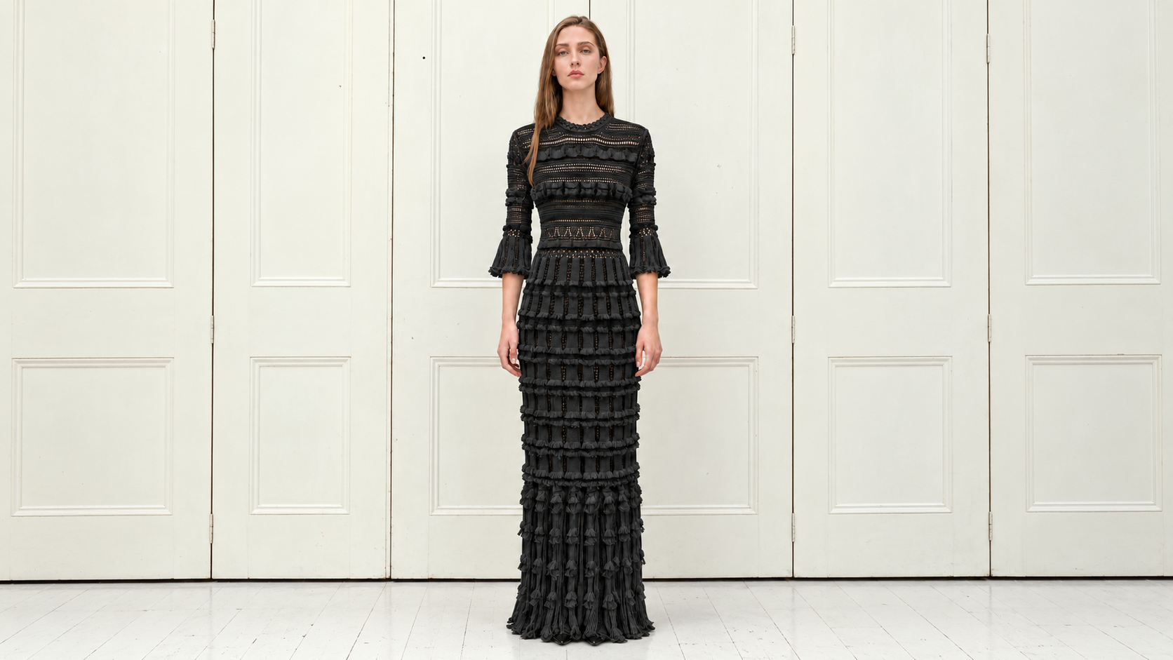 Alice Lee — black knit dress against cream panelled doors